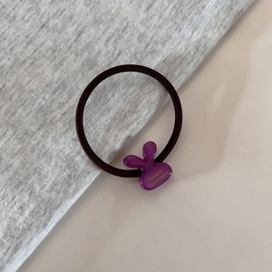 Detail of purple rabbit resin charm on brown elastic hair tie with France Handmade text