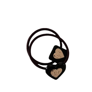 Minimalist elastic hair ties with black resin heart and square shapes and gold metal accents