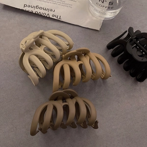 Extra large matte pumpkin hair claws in cream, beige, brown, and black colors