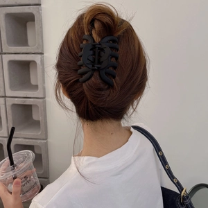 Matte black oversized hair claw clip for thick hair shown from behind on model