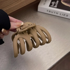 Close-up of a large mocha brown matte claw clip showing strong metal spring and teeth