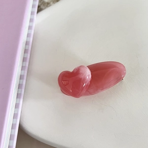Close-up of pink marble acrylic heart hair clip showing detailed glossy resin texture