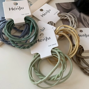 Detail of high-elasticity braided hair bands in Morandi colors on display cards