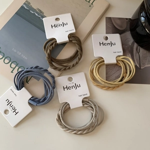 Detail of high-elasticity braided hair bands in Morandi tones on display cards