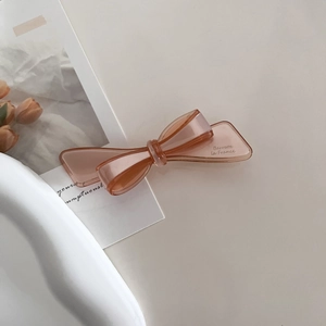 Detail of amber acetate bow hair clip with Barrette La France gold engraving