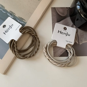 Morandi elastic hair ties in olive green and light grey on a white display card