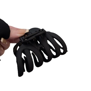Large matte black pumpkin hair claw clip for thick hair styling in minimalist design