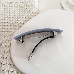 Detail shot of lilac matte rectangular spring hair clip with silver metal interior