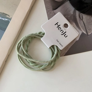 Detail of high-elasticity hair bands in Morandi green with textured weaving and card