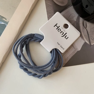 Detailed view of Morandi blue elastic hair bands set with smooth and braided textures