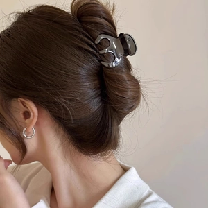Deep grey glossy pumpkin hair claw clip shown in a stylish updo on a female model