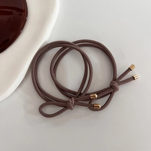Brown elastic hair ties set with gold metal cylinders for women's hair styling