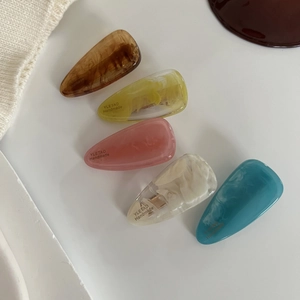 Five-piece set of amber acetate teardrop hair clips in multiple marble colors