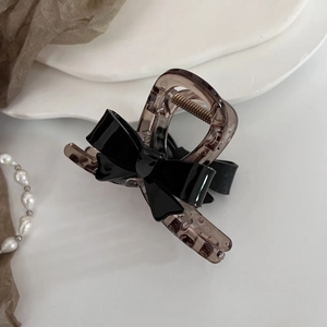 Pince à cheveux élégante en acrylique avec nœud en ambre et noir pour coiffure quotidienne