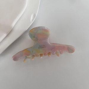 Close-up of acetic acid hair claw clip with marble texture and Barrette la France text