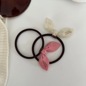 Close-up of rabbit ear hair ties with handmade logo and high elastic brown band