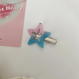 Close-up of a Y2K pink and blue gradient star hair clip with polished resin finish