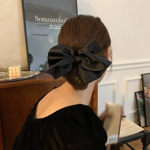 Elegant large black satin bow hair tie for French style updos and women's hairstyles
