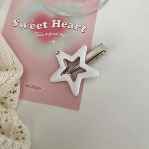 Detailed view of Y2K white star hair clip with silver metal duckbill attachment