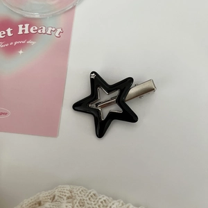 Detail of Y2K star hair clip with black hollow pentagon design and metal duckbill clasp