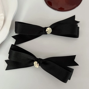 Elegant pair of black satin ribbon bow hair clips with gold metal brand detailing