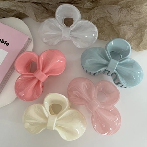 Set of five elegant resin hair claws with jelly-finish bow designs in pastel colors