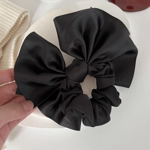 Elegant oversized black satin bow scrunchie for women with high elasticity and silk texture