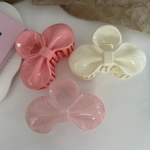 Three-piece set of sweet jelly pink and cream bow hair claws for elegant hairstyling