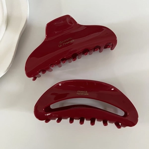 Set of two burgundy acetate hair claws including arched and hollow semicircle designs