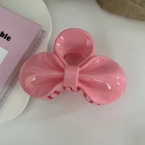 Detailed top view of large pink jelly resin bow hair claw clip with glossy finish