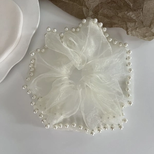 Elegant white mesh oversized scrunchie with faux pearl trim on a white tray