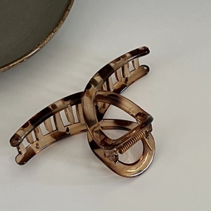 Tortoiseshell claw clip with strong metal spring for thick hair on a white background