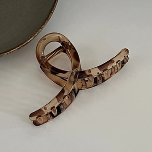 Detail of amber tortoiseshell large hair claw clip with strong metal spring for thick hair