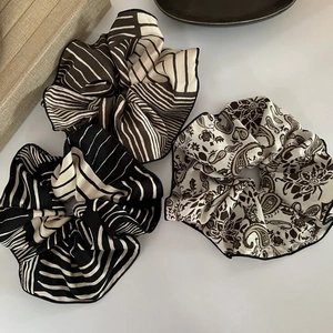 Three-piece satin scrunchies set featuring stripes and paisley patterns in neutral tones