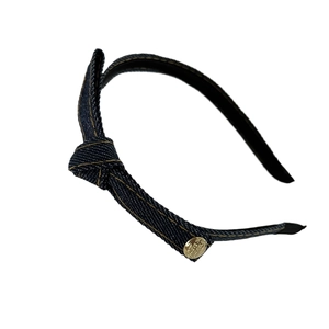 Retro dark blue denim headband with bow knot and gold metal buckle on white background