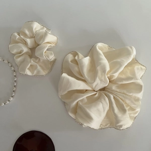 Set of two cream satin hair scrunchies with elegant sparkling beads and silk-like texture