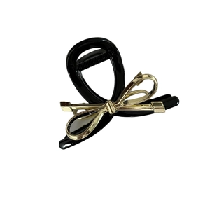 Elegante molletta per capelli in resina nera con fiocco in metallo dorato da donna