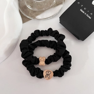 Cute black elastic scrunchies set with gold bear and rabbit metal charms on cards