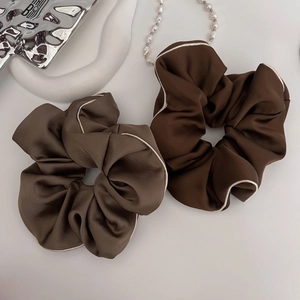 Elegant satin hair scrunchies in mocha and dark brown colors with white contrast piping edge