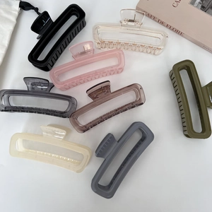Set of 7 colorful 13cm jelly claw clips in various matte and glossy finishes on white background