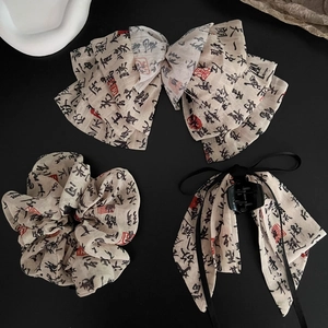 Detailed view of Chinese calligraphy print hair accessories set with ribbon and bow