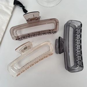 Detailed macro view of large 13cm jelly-colored rectangular hair claws in three colors
