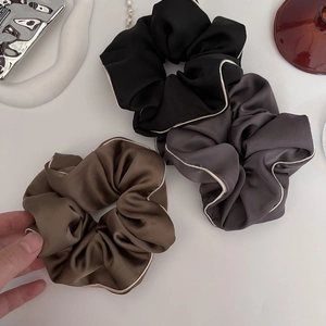 Set of three satin hair scrunchies in black grey and brown with white contrast piping