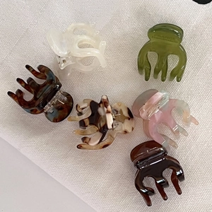 Mini acetate hair claw clips set in various colors like marble and tortoise shell