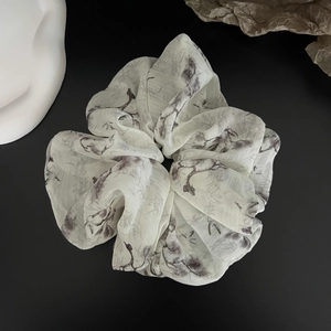 Macro detail of Chinese ink wash print hair scrunchie with elegant chiffon floral texture