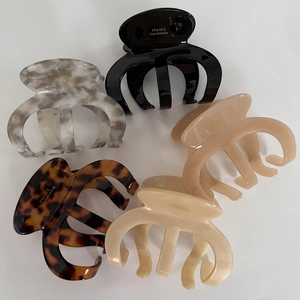 Set of 5 vintage acetate claw clips in marble, leopard, and solid colors on white background