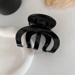 Elegant black acetate hair claw clip with glossy finish and durable French style design