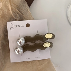 French style brown wavy pearl hair clips set on a minimalist white display card