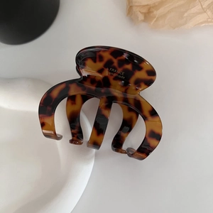 Close-up of tortoise shell acetate hair claw clip with golden France handmade logo