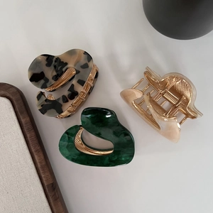 Irregular acetate hair claws with leopard and marble patterns and gold metal springs